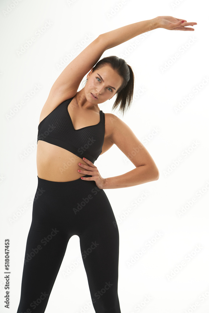`Perfect slim tanned young female body in sportswear. Concept perfect body, no fat, motivation, healthy lifestyle, fitness routine. Isolated white background.