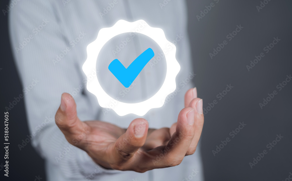 Businessman hand shows the sign of the top service Quality assurance on gray background, Guarantee, Standards, ISO certification and standardization concept. Businessman hand shows the sign of the top service Quality assurance on gray background, Guarantee, Standards, ISO certification and standardization concept.