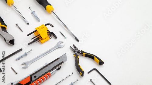 DIY Tool For Building Or Repairing On White Background. The Workplace Of The Foreman. Professional Repair And Construction Tool. Space For Text. Screwdriver, interchangeable nozzles, wrench, pliers.