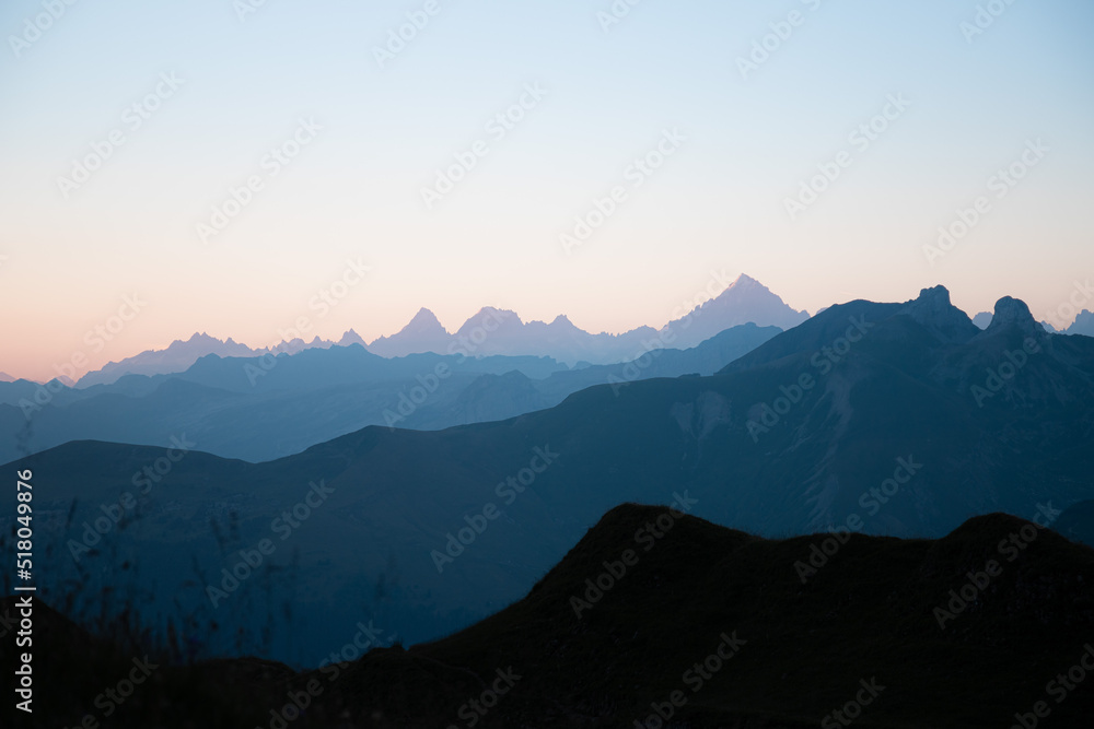 First sunlight on the mountains of the Lac de Peyre in French Alps. Mountain layers at sunrise