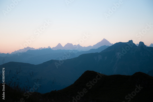 First sunlight on the mountains of the Lac de Peyre in French Alps. Mountain layers at sunrise