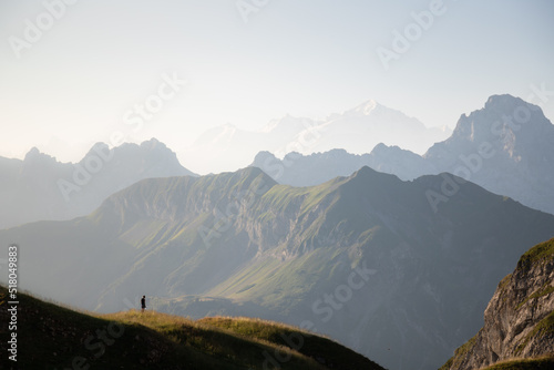 Tableau sur toile Man silhouette staring at the vastness of the mountains surrounding him