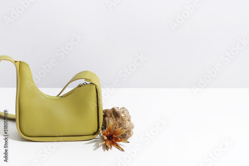 Green eco bag on white background. Concept of vegan leather, sustainable alternative, nature protection, zero waste lifestyle, no waste production, copyspace © Елена Юдина