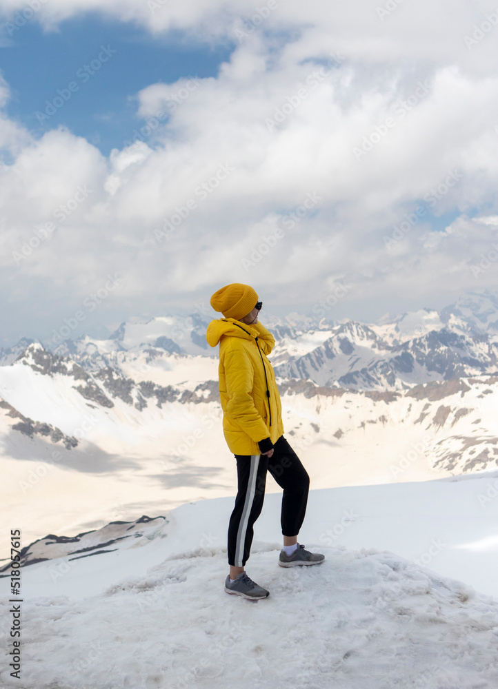 Happy young girl travels in winter mountains. Winter holidays concept Happy young girl travels in winter mountains. Winter holidays concept