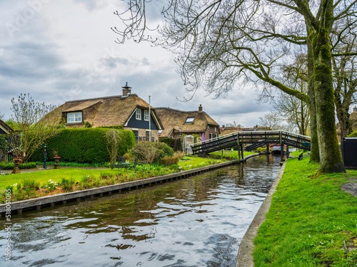 Dutch house and wodden bridge in the charming village of Giethoorn, Netherlands