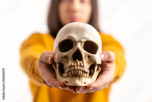 caucasan medical student holding an artificial molder of a human skull - isolated closeup. High quality photo © PoppyPix