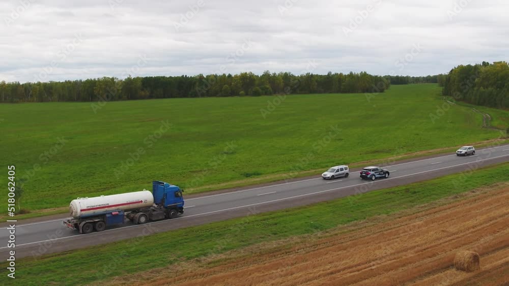 Cars and trucks are driving along the road Cars and trucks are driving along the road