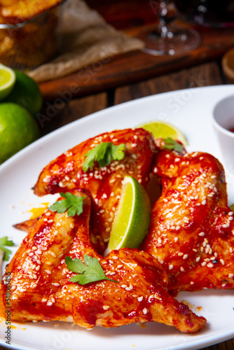 chicken wings with potato wedges and sezam.