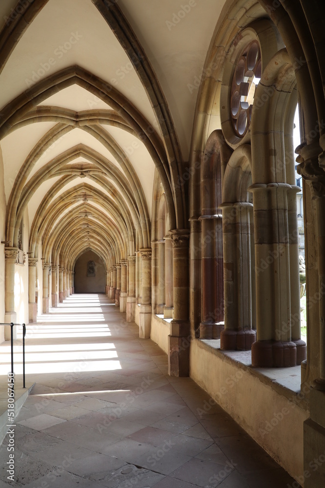 symmetric cloister hallway around a courtyard connecting the abbey to the church