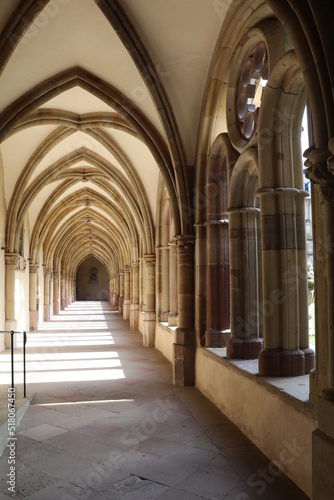 symmetric cloister hallway around a courtyard connecting the abbey to the church