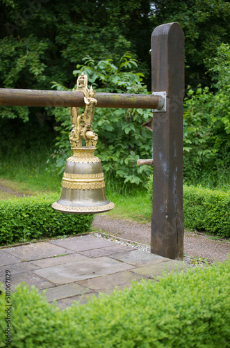 decorative golden bell hanging in the garden