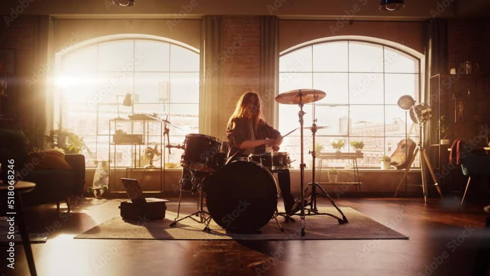 Expressive Drummer Girl Playing Drums in a Loft Music Rehearsal Studio Filled with Light. Rock Band Music Artist Learning a New Drum Solo. Zoom In Shot. Expressive Drummer Girl Playing Drums in a Loft Music Rehearsal Studio Filled with Light. Rock Band Music Artist Learning a New Drum Solo. Zoom In Shot.