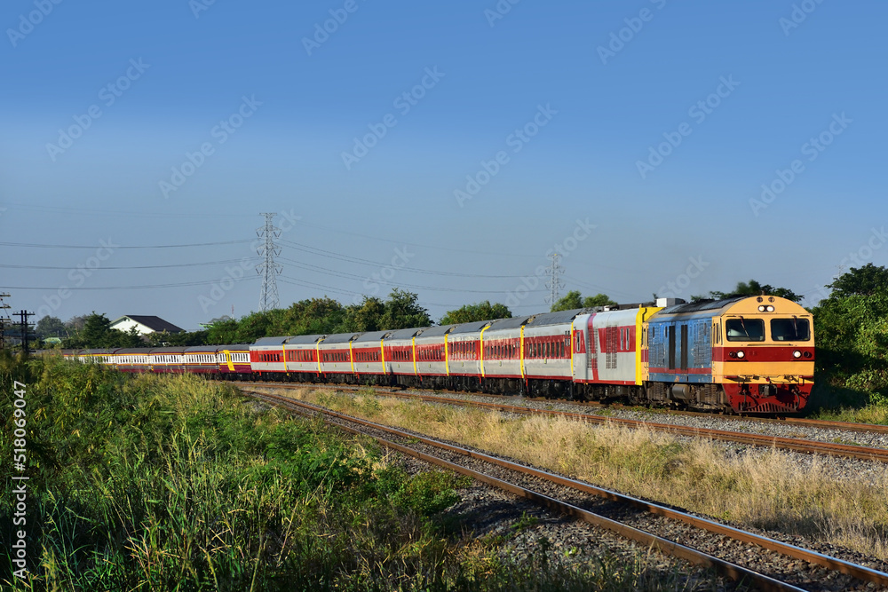 Passenger train by diesel locomotive on the railway in Thailand Passenger train by diesel locomotive on the railway in Thailand
