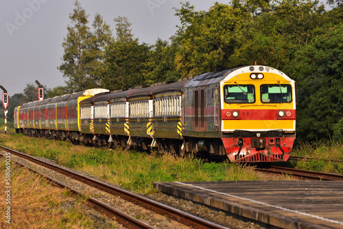 Passenger train by diesel locomotive on the railway in Thailand