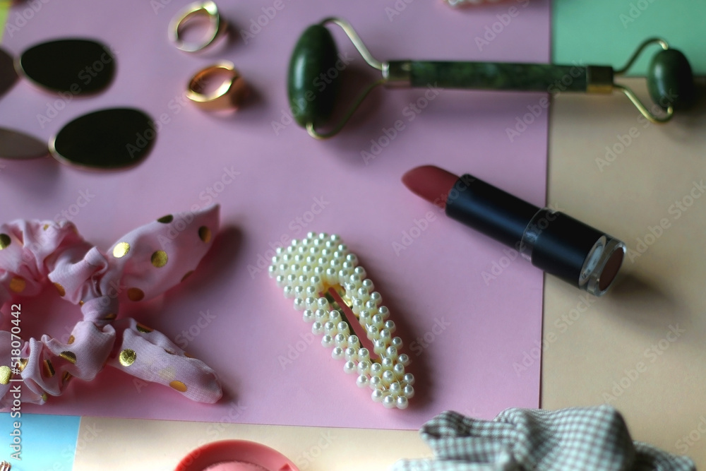 Various accessories, make up products and jewelry on various colorful pastel backgrounds. Selective focus. Various accessories, make up products and jewelry on various colorful pastel backgrounds. Selective focus.