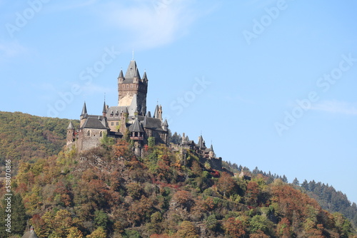 Medieval castle of Cochem, Germany on top of the hill with the trees in fall colors