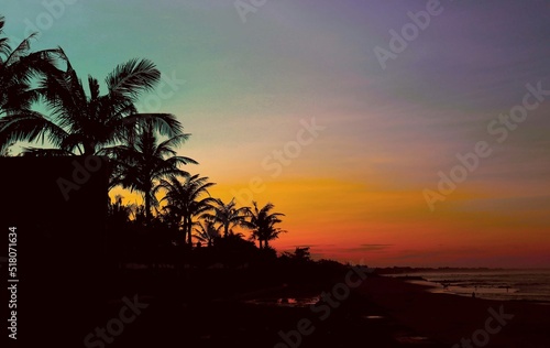 sunset over the beach and palm trees