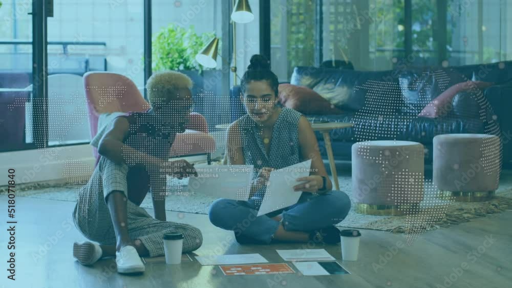 Animation of globe and data over diverse women working in office Animation of globe and data over diverse women working in office