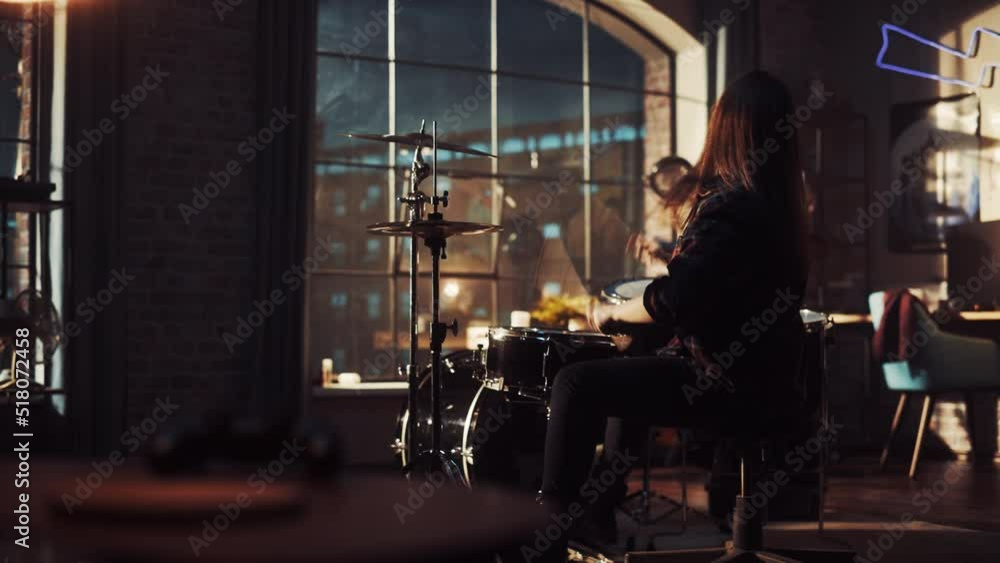 Portrait of a Young Drummer Playing at a Band Rehearsal, Doing Tricks with Drumsticks. Learning Drum Solo on Drums and Cymbals in Living Room Loft Apartment. Evening or Night Jam Session. Portrait of a Young Drummer Playing at a Band Rehearsal, Doing Tricks with Drumsticks. Learning Drum Solo on Drums and Cymbals in Living Room Loft Apartment. Evening or Night Jam Session.
