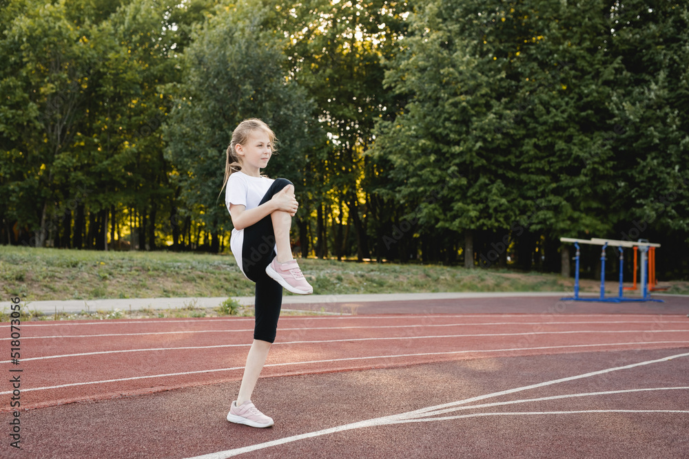 Child girl doing warm-up exercises before running