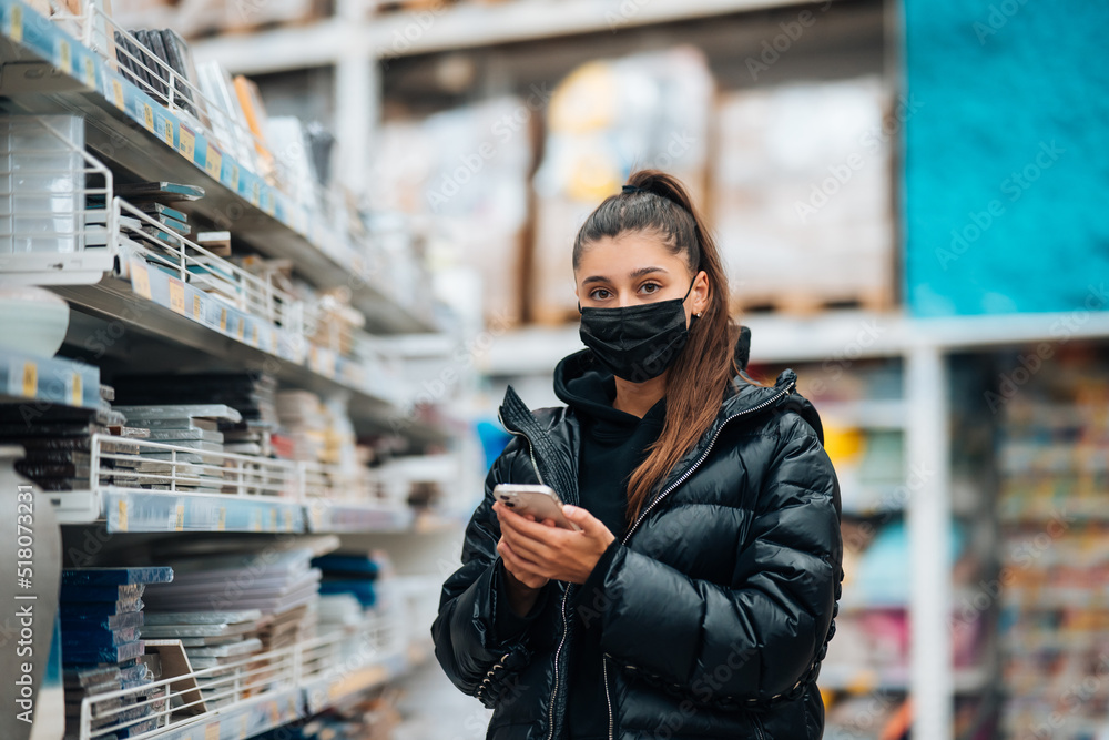 Woman with face mask buying during virus pandemic.