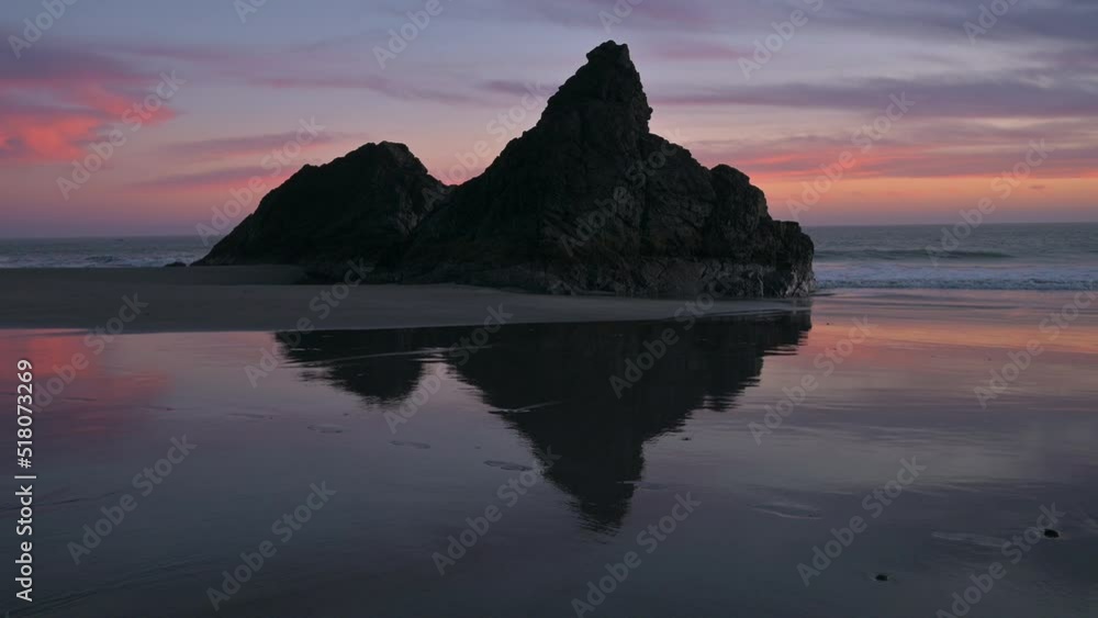 Rock reflection in wet sand. Sunset in Brookings, Oregon at Harris Beach. Rock reflection in wet sand. Sunset in Brookings, Oregon at Harris Beach.