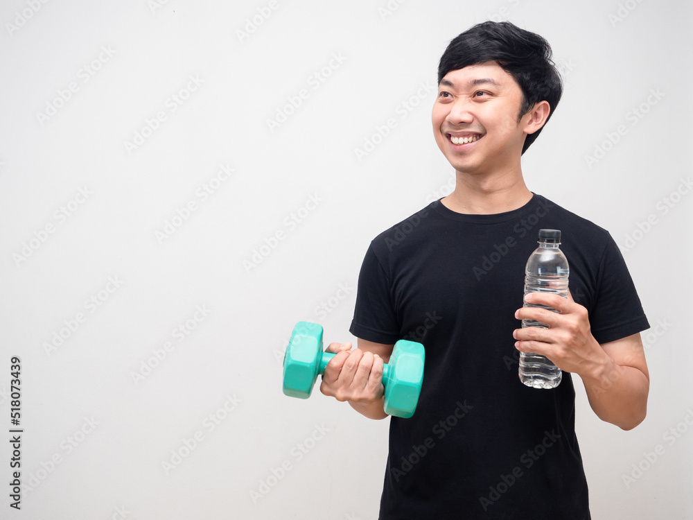 Young man good healthy smile hold dumbbell with water bottle isolated Young man good healthy smile hold dumbbell with water bottle isolated
