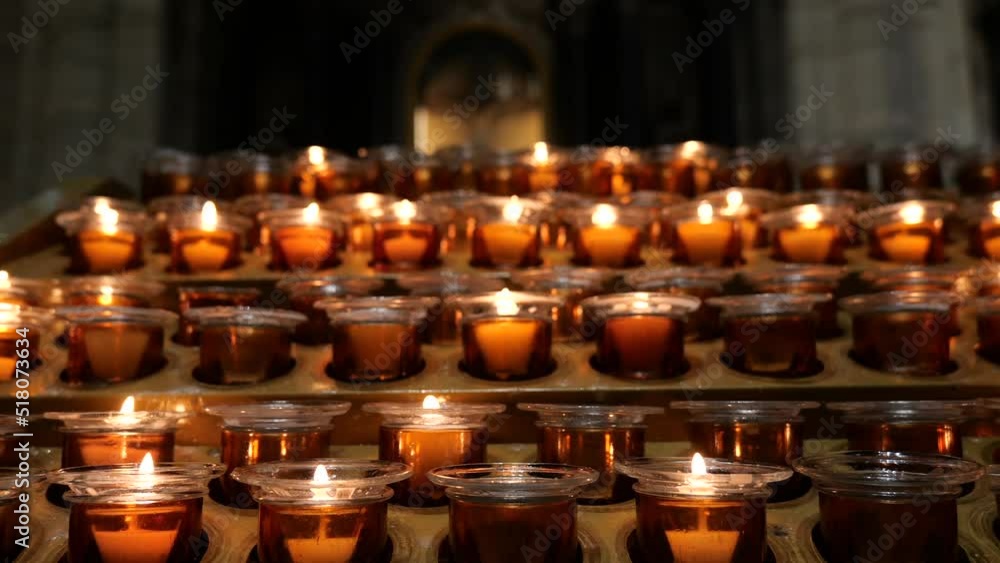4k video with a lot of candles lit up in a church in memory of the ...