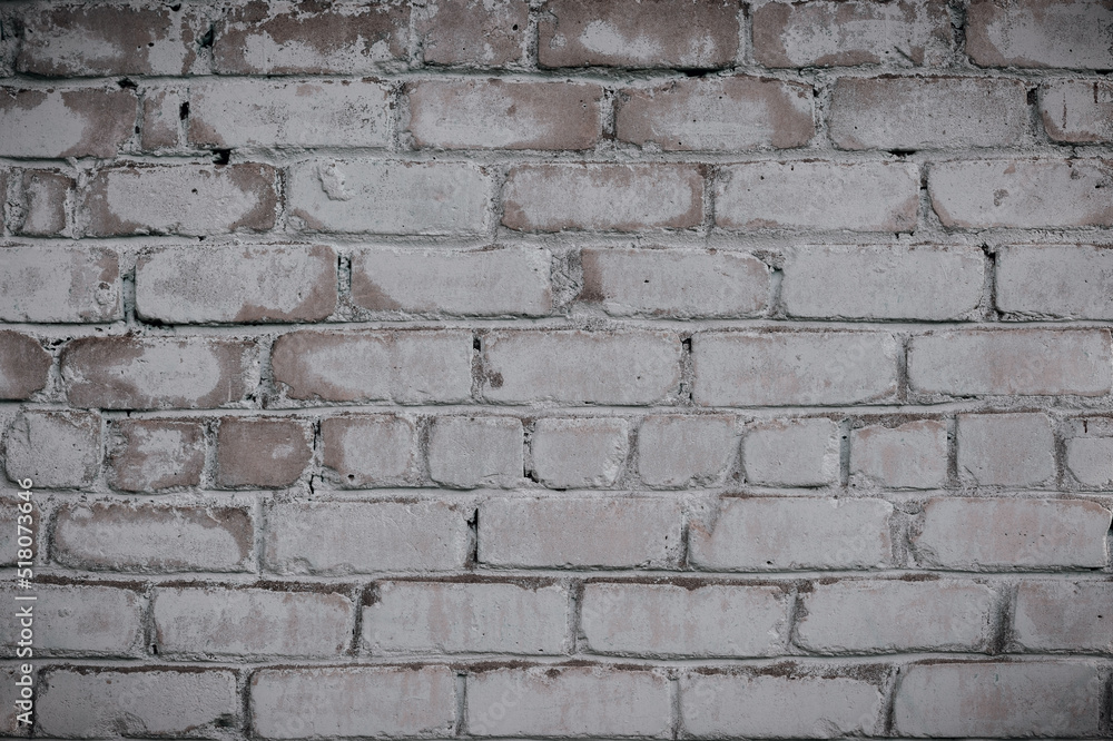 An old brick wall with remnants of white paint. Background An old brick wall with remnants of white paint. Background