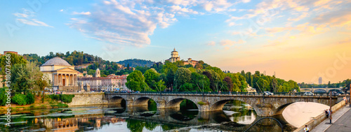 Turin, Italy. Panoramic view at sunset of the Po River, the Church of the Gran Madre, the Church of Monte dei Cappuccini and the Vittorio Emanuel I Bridge. July 13, 2022. photo