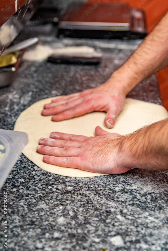 hand of chef baker making pizza at kitchen. The process of making pizza. cooking italian pizza
