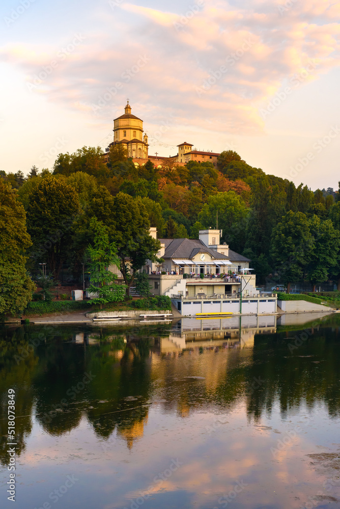 Obraz premium Turin, Italy. Sunset view of the Church of Santa Maria al Monte dei Cappuccini with the clouds below reflected in the River Po. Vertical image. July 13, 2022.