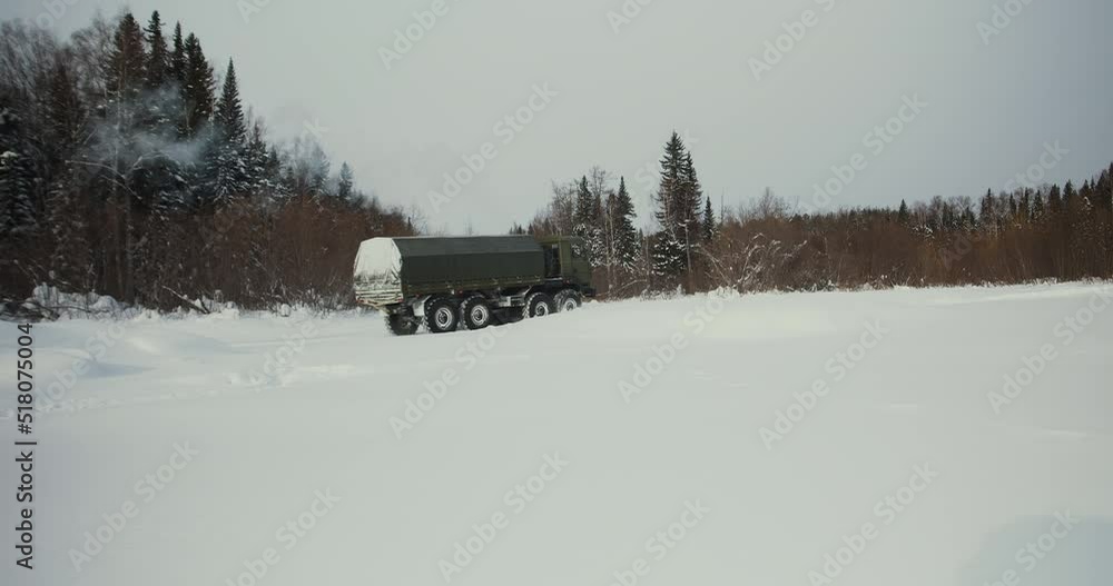 Off-road truck crosses the river in winter, side view. Off-road truck crosses the river in winter, side view.