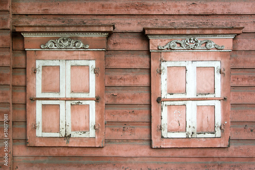 Old closed wooden windows in an emergency house. photo