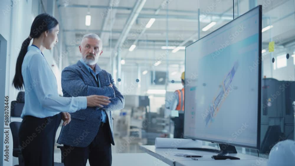 Factory Office Meeting: Engineer Talking with Industrial Parts Supplier About a Business Venture and Collaboration on Next Generation Hydraulics Mechanism for Heavy Industry Equipment. Factory Office Meeting: Engineer Talking with Industrial Parts Supplier About a Business Venture and Collaboration on Next Generation Hydraulics Mechanism for Heavy Industry Equipment.