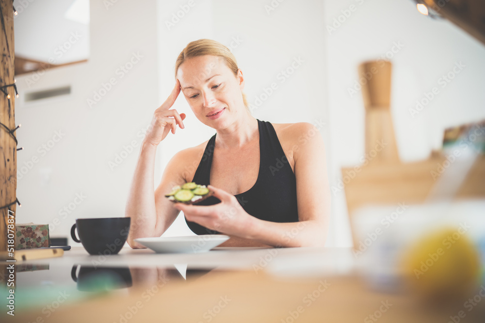 Beautiful sporty fit young pregnant woman having a healthy snack in home kitchen. Healty lifestyle concept. Beautiful sporty fit young pregnant woman having a healthy snack in home kitchen. Healty lifestyle concept.