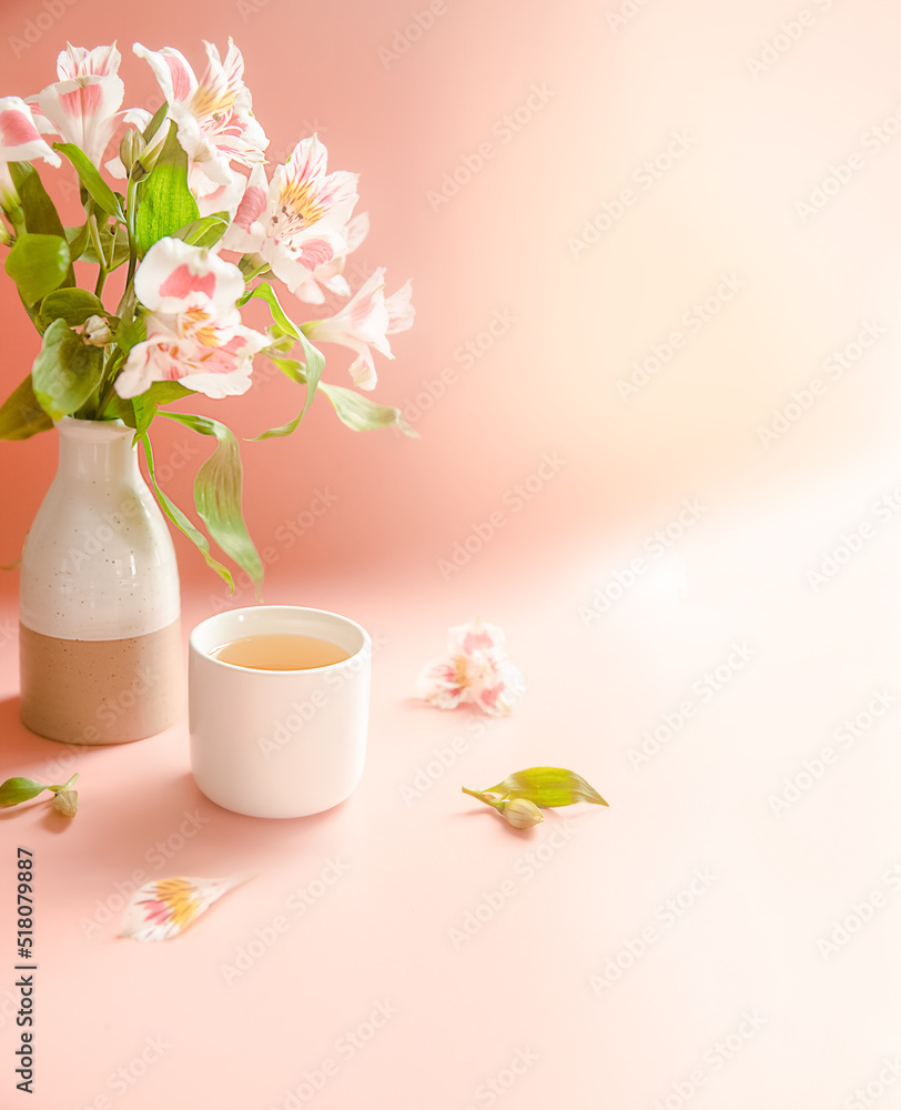 flower and herb tea in a tea cup on pink background with space for your text