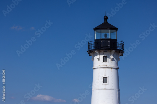 A lighthouse against a blue sky. photo
