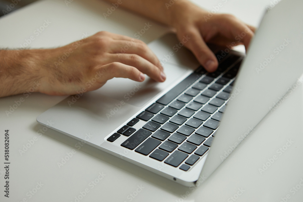 a man working on a laptop, his hands close up a man working on a laptop, his hands close up