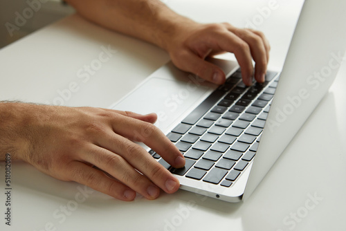 a man working on a laptop, his hands close up