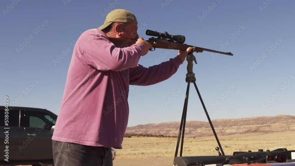 Man shoots powerful rifle toward a steel target down range. Preparation