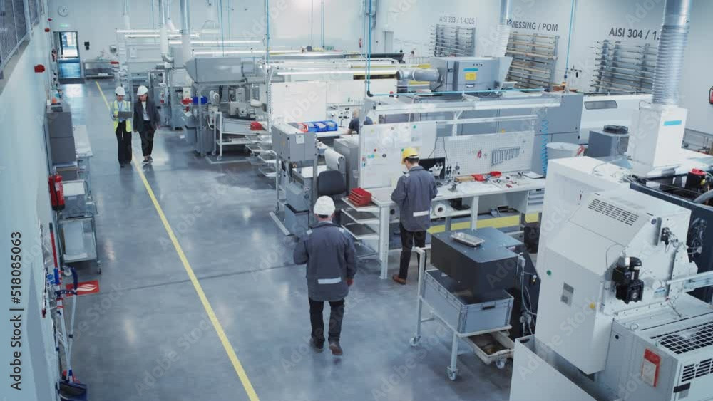 Industrial Factory: Team of Engineers, Technicians, Specialists and Workers, Working on Production Plant, Developing CNC Parts, Programming Machines, Executing Orders. Slow Motion Elevated Footage. Industrial Factory: Team of Engineers, Technicians, Specialists and Workers, Working on Production Plant, Developing CNC Parts, Programming Machines, Executing Orders. Slow Motion Elevated Footage.