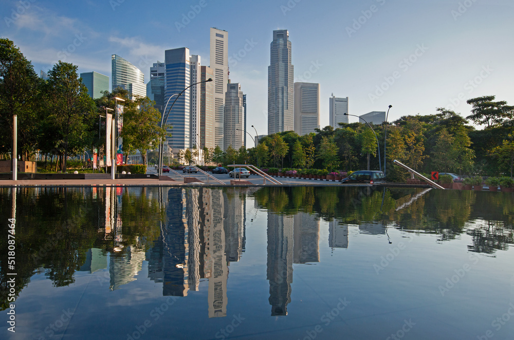 Financial district and skyscrapers of Marina Bay reflected in Pool at the Esplanade at sunset