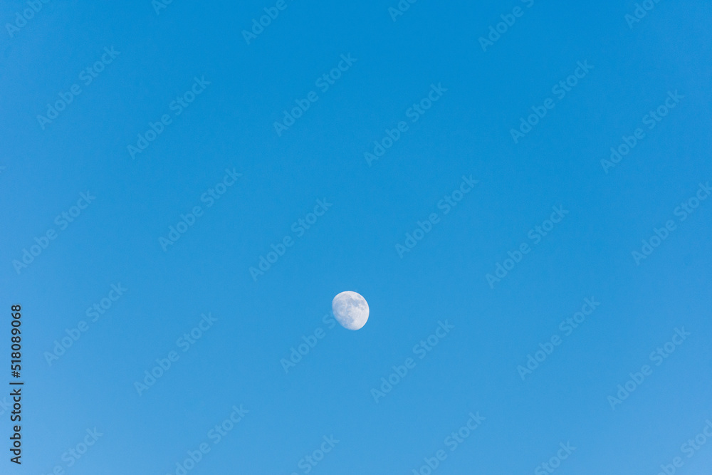 Moon against blue sky in the countryside. Moon against blue sky in the countryside.