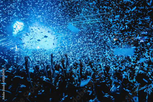 crowd of people dancing with confetti