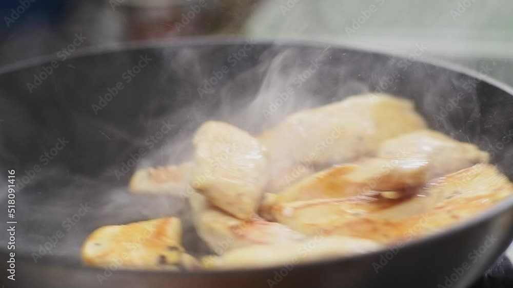 Cooking and stirring of pieces chicken breasts in frying pan, slow motion. Cooking and stirring of pieces chicken breasts in frying pan, slow motion.