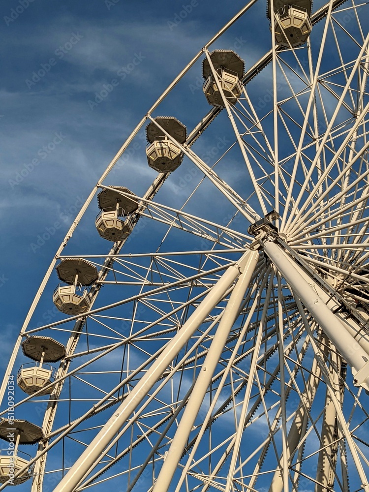 Ferris wheel on a blue sky in the sunny day