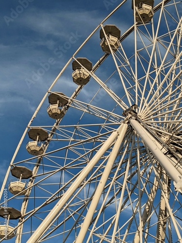 Ferris wheel on a blue sky in the sunny day