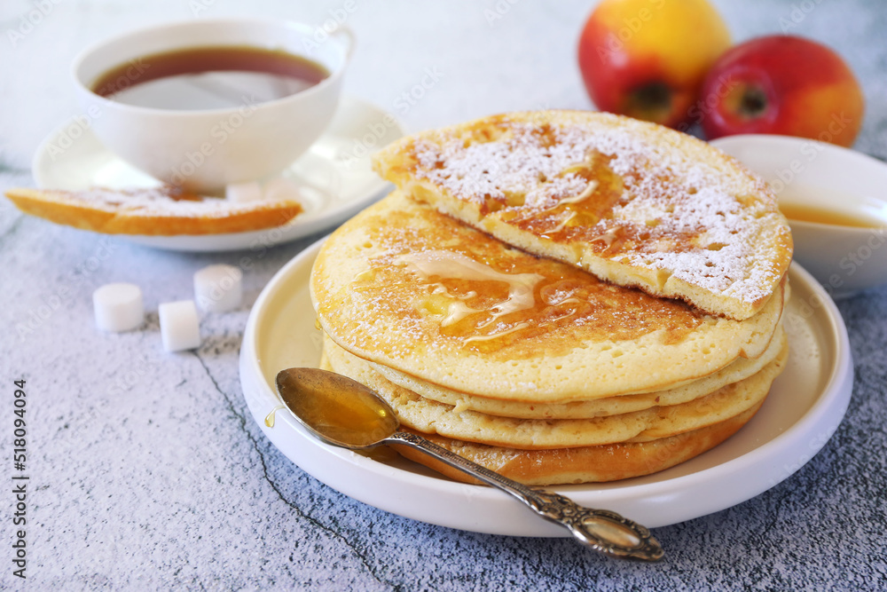 French cuisine. Matefaim. Sweet Apple Pancakes, honey dressing and cup of tea French cuisine. Matefaim. Sweet Apple Pancakes, honey dressing and cup of tea