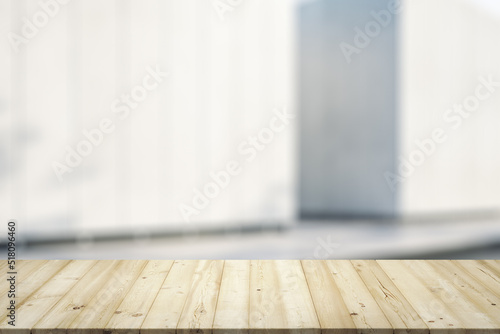 Empty wooden table with light sunny exterior wall on background, mock up © Pixels Hunter